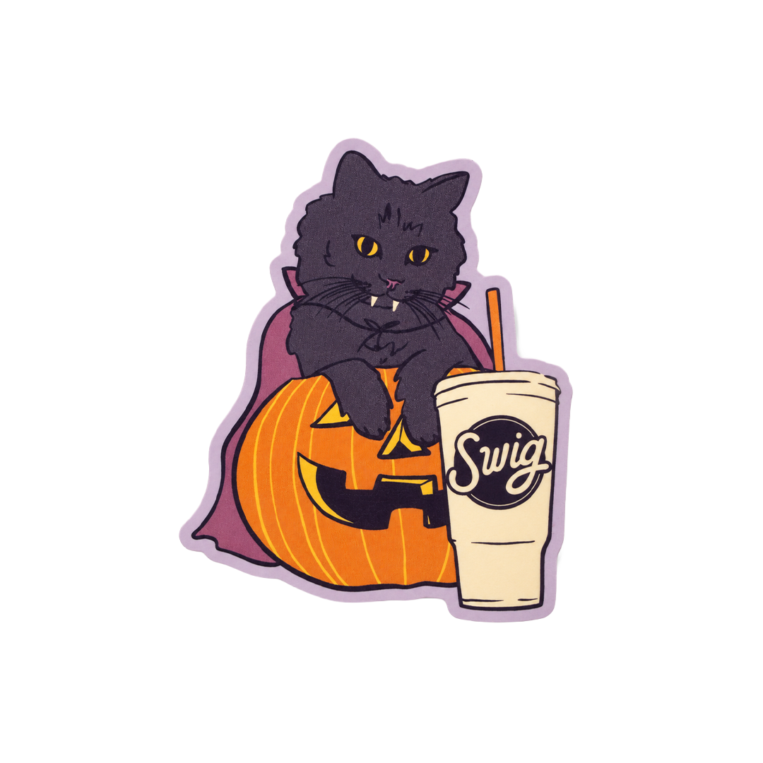 The cat sticker in normal light, with a pumpkin and Swig cup.