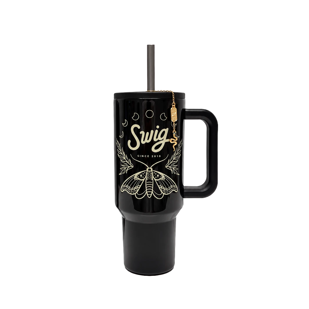 Black Witching Hour Tumbler with cream moth and moon artwork, a handle, straw, and gold tone charm.
